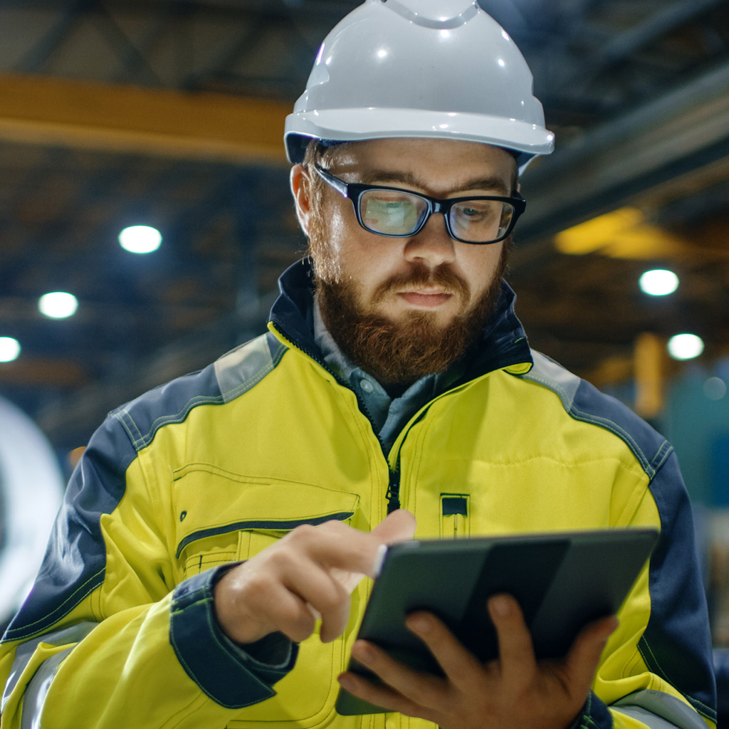 Site professional reviewing engineering insurance coverage for machinery and operations