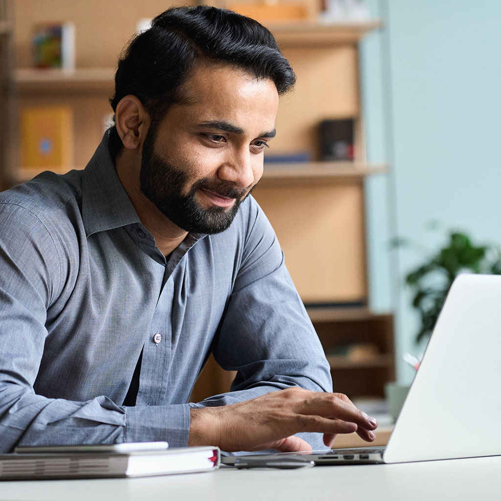 Smiling man representing Sukoon’s Enhanced Plus or Comprehensive Health Plan for corporate clients