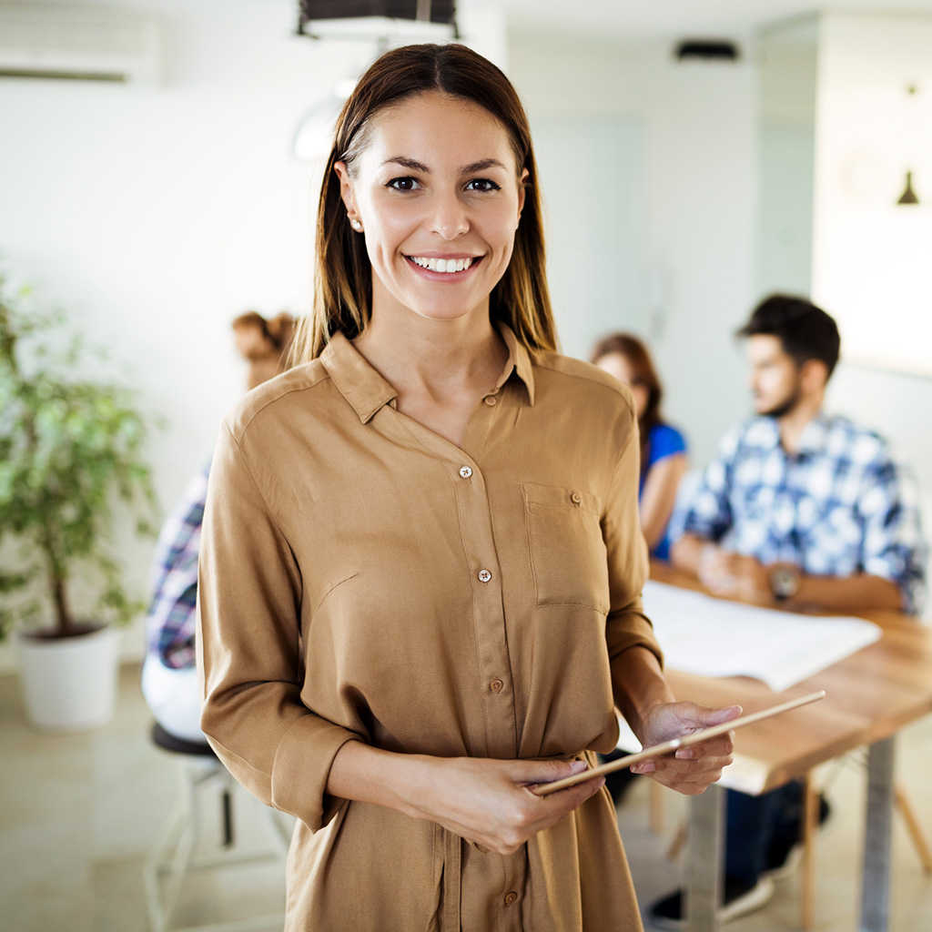 Professional woman engaging in a discussion about group life insurance benefits in a corporate setting